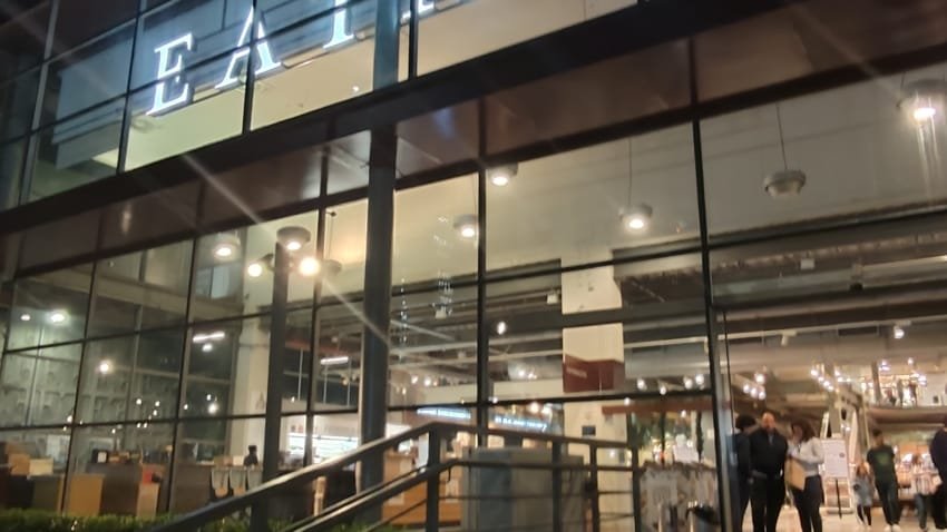 iew of Eataly São Paulo’s main entrance at night with glass façade and illuminated sign