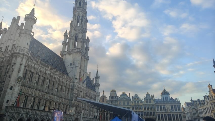 Things to Do in Belgium: Complete Guide with 21 Must-See Experiences✨ 1 View of the Grand Place in Brussels at sunset with historic buildings and crowds of tourists in the square.
