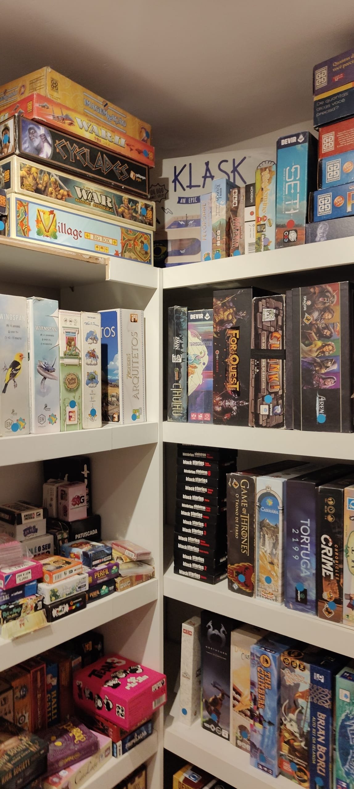 Shelves full of various board games at Luderia Carioca, showing the wide collection available to visitors.