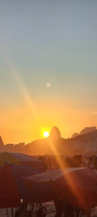 Rio de Janeiro 1 Sunset on the beach in Rio de Janeiro with a silhouette of the South Zone mountains and people enjoying the evening